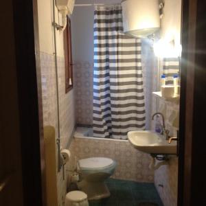 a bathroom with a toilet and a sink and a shower at FILIPPOS-Spectacular area,,,,panoramic,-sea- view- apartments-49m, just call on the photo number, for price,vacancy etc,,-next to Vallis hotel,, 15meters from seaside!!! in Agria