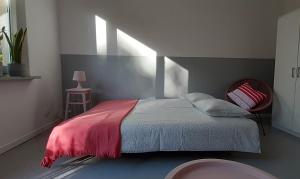 a bedroom with a bed with a red blanket at Lovely Madly Apartment in Krakow