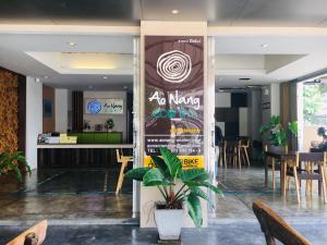 a restaurant with a sign in the middle of a room at Aonang Eco Inn Krabi in Ao Nang Beach