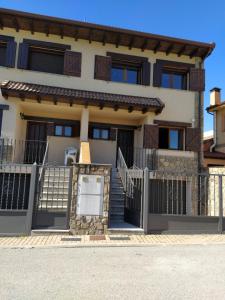 a house with a gate in front of it at Parque Sierra Norte in Rascafría