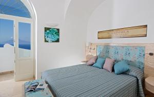 a bedroom with a bed in a room with a window at Capri Wine Hotel in Capri +29 photos