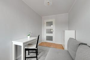 a living room with a table and a couch at Apartament z widokiem na morze in Sopot