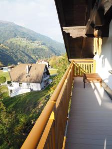 a balcony with a bench and mountains in the background at Haus Gabriel in Fliess