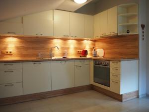 a kitchen with white cabinets and a sink at Haus Gabriel in Fliess