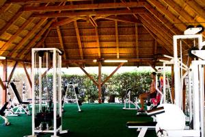 a gym with white tread machines and a person in the gym at Happy Camp mobile homes in Camping Village Free Time in Marina di Bibbona