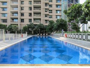 a swimming pool in front of a tall building at Frank Porter - 29 Boulevard in Dubai