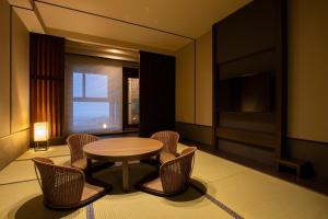 a room with a table and chairs and a television at Niseko Prince Hotel Hirafutei in Kutchan +38 photos