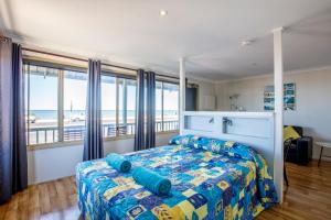 A bed or beds in a room at Shark Bay Seafront Apartments