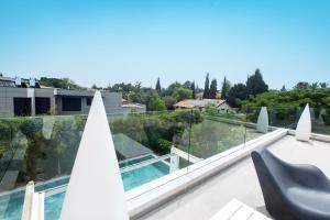 a view from the balcony of a house with a swimming pool at The Mansion by Five Stay in Herzliya B