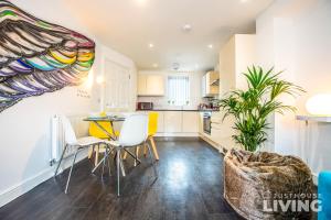 a kitchen and dining room with a table and chairs at Liverpool House - Stunning Townhouse with FREE Parking for 4 cars - Close To Centre in Liverpool