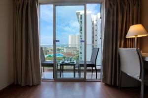 a room with a large window with a table and chairs at Starlit Suites Bangalore in Bangalore