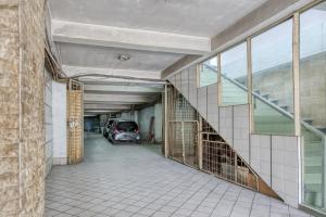 a parking garage with a car parked in it at RedDoorz Plus near Jakarta Kota Station in Jakarta