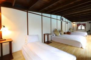 Una cama o camas en una habitación de Jiang's B&B 江院子庭園民宿