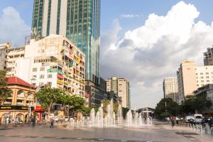 a fountain in the middle of a city with buildings at CIRCADIAN Industrial Studios on Nguyen Hue in Ho Chi Minh City