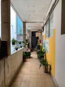 an empty hallway with potted plants in a building at CIRCADIAN Industrial Studios on Nguyen Hue in Ho Chi Minh City