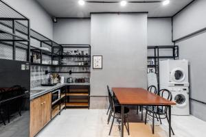 a kitchen and dining room with a table and chairs at CIRCADIAN Industrial Studios on Nguyen Hue in Ho Chi Minh City