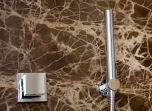 a close up of a bathroomaucet on a marble counter at Capri Wine Hotel in Capri