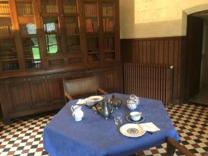 a table with a blue table cloth in a room at Château de Villers-Châtel in Villers-Châtel
