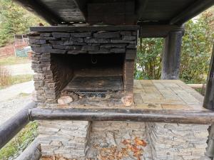 an outdoor fireplace with a stone oven at Coliba Drumetului in Vatra Dornei