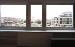 a group of windows with a view of a city at Urbantec Realty - Plaza de Colón in Madrid