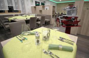 a table with glasses and silverware on a yellow table cloth at Gasthof Seelhofer in Prigglitz