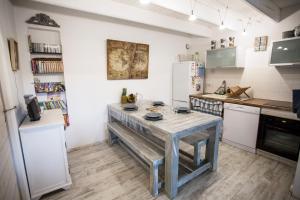 a kitchen with a table in the middle of it at La Maison Bleue in Baden
