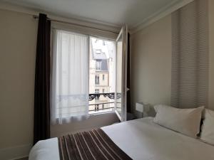 Krevet ili kreveti u jedinici u okviru objekta Hôtel Océanic - Grands Magasins