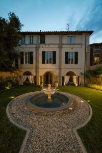 a fountain in front of a large building at LUCUS Exclusive Bed and Breakfast in Lucca