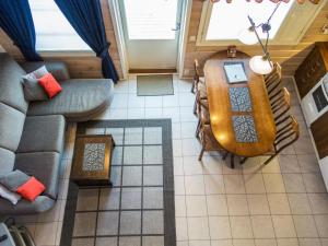 an overhead view of a living room with a table and a couch at Holiday Home Karitahko a 8 by Interhome in Tahkovuori +5 photos
