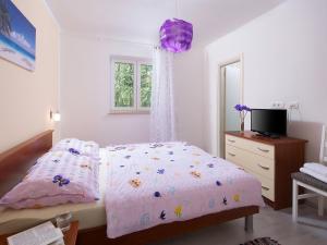 a bedroom with a bed and a dresser and a mirror at Holiday Home Ana by Interhome in Trget