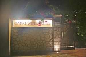 a sign that reads carril wine world next to a gate at Capri Wine Hotel in Capri