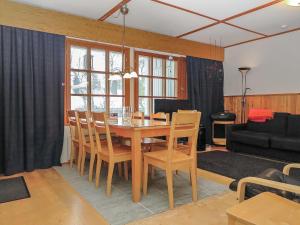 a living room with a dining room table and chairs at Holiday Home Saariselän väärtin kammi 1 by Interhome in Saariselka