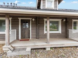 a front porch of a wooden house with a door at Holiday Home Ylläksen rinnemäki b by Interhome in Ylläs