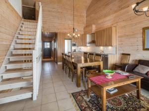 a kitchen and living room with a staircase in a cabin at Holiday Home Ylläksen rinnemäki b by Interhome in Ylläs