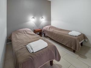 a room with two beds with towels on them at Holiday Home Yllästar 3 as 616 by Interhome in Äkäslompolo