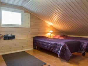 a attic bedroom with two beds and a window at Holiday Home Karitahko a 8 by Interhome in Tahkovuori