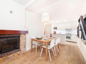 a dining room with a table and a fireplace at Holiday Home Paris by Interhome in Calonge +16 photos