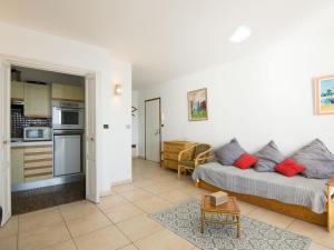 a living room with a couch and a kitchen at Apartment Le Bellevue-1 by Interhome in Dinard +14 photos