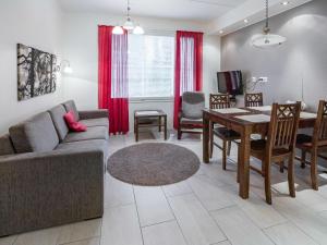 a living room with a couch and a table at Holiday Home Yllästar 3 as 616 by Interhome in Äkäslompolo