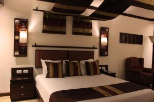 Ein Bett oder Betten in einem Zimmer der Unterkunft Africana Hotel & Spa