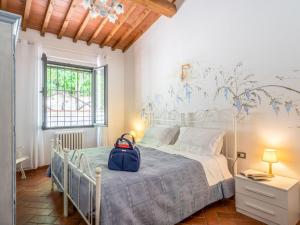 a bedroom with a bed with a backpack on it at Holiday Home Villa Lavinia by Interhome in Montevarchi