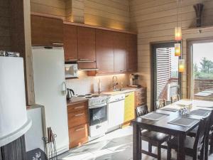 ルカにあるHoliday Home Masto 4 by Interhomeのキッチン(木製キャビネット、テーブル、冷蔵庫付)