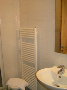 a white bathroom with a sink and a mirror at Albergo Verdi in Padova