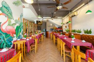 a dining room with tables and chairs and a restaurant at An Phú Hà Nội Hotel & Spa - Mỹ Đình in Hanoi