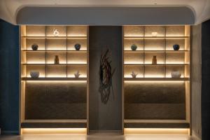 a room with shelves with differentiatesiatesiatesiatesiatesiatesiatesiatesiatesiates at THE BLOSSOM HAKATA Premier in Fukuoka +88 photos