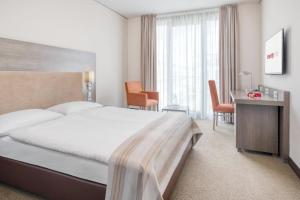Postel nebo postele na pokoji v ubytování IntercityHotel Dresden