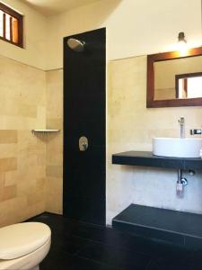 a bathroom with a toilet and a sink at Noka Homestay in Sidemen