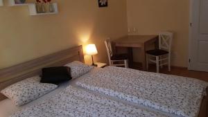 a bedroom with a bed and a table with a table at Apartman Lotos in Mikulov +1 photo
