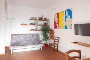 a living room with a couch and a flat screen tv at Appartamento 122 in Prato