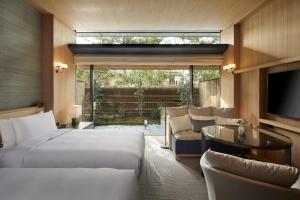 a hotel room with two beds and a television at Park Hyatt Kyoto in Kyoto